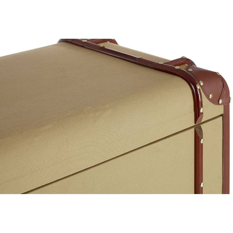 The Columbus Trunk Style Chest features a sleek, rectangular design with a smooth, golden surface and brown leather accents. The corners are reinforced with metal studs, and there are two drawers visible at the front, each with a simple handle. The overall aesthetic combines vintage charm with modern functionality