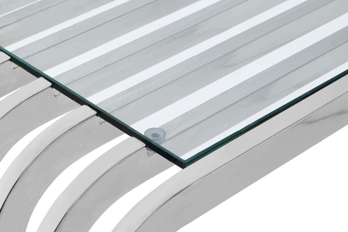 Closeup of glass table top on stainless steel slatted base with modern design