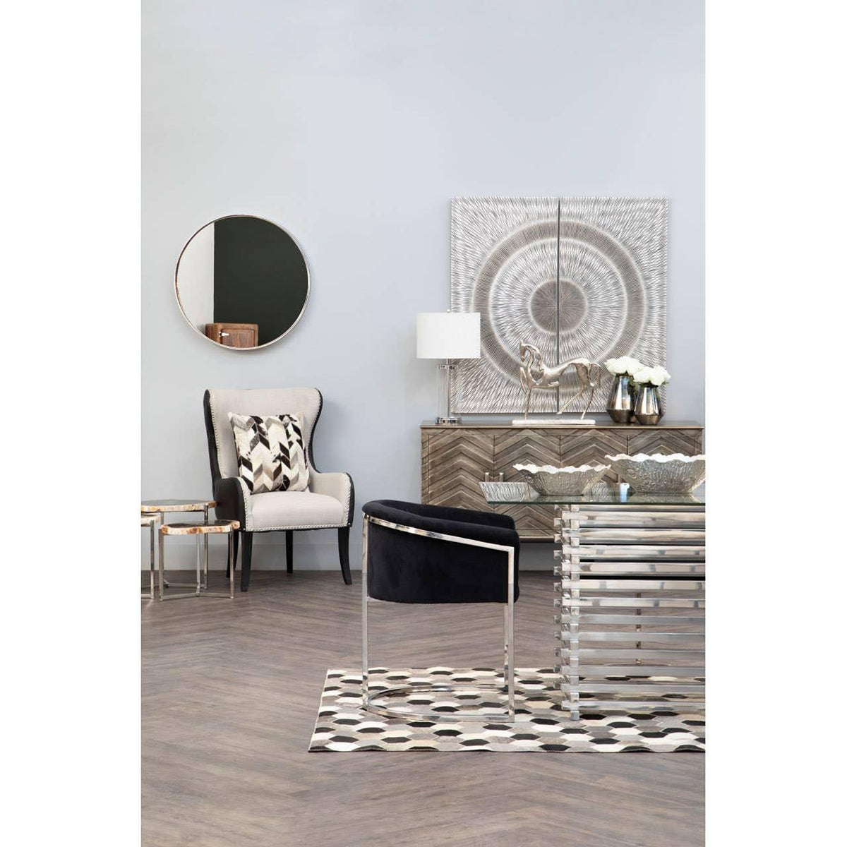 Modern living room with black velvet armchair, metal coffee table and patterned rug