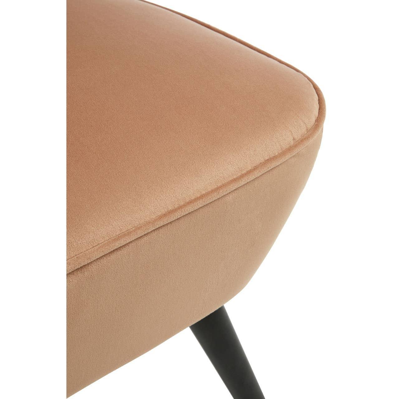 Close up of beige velvet dining chair seat with black angled leg