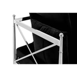 Close-up view of the backrest and frame of a two-seater sofa featuring a sleek black velvet upholstery and a shiny silver metal frame with a crisscross design. The sofa's elegant lines and modern aesthetic are highlighted by the contrast between the soft fabric and the metallic elements