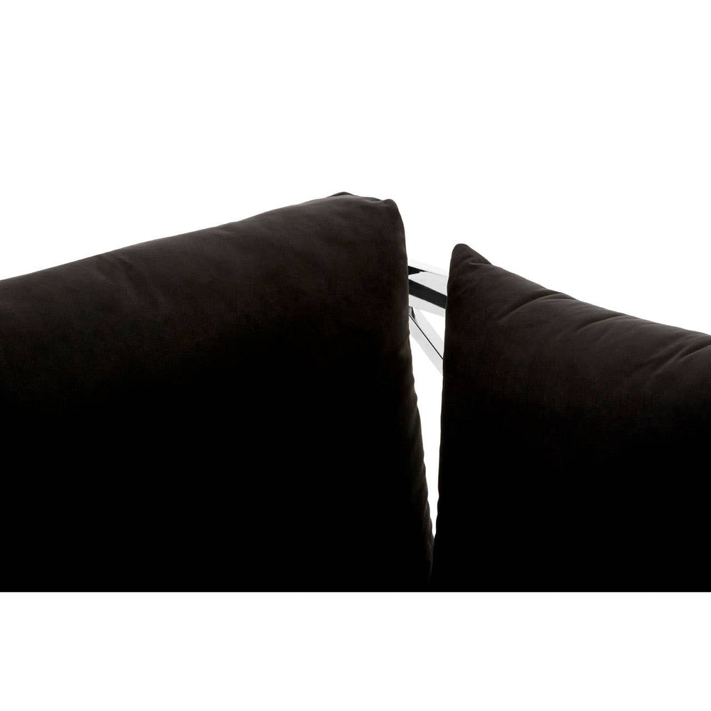 Close-up view of the black velvet upholstery on a three-seater sofa, highlighting the seam between two cushions. The fabric appears soft and plush, with a subtle sheen. The edges of the cushions are neatly finished, showcasing the quality of the material