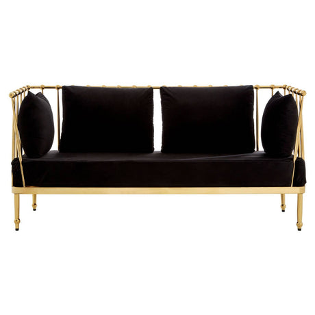 A sleek two-seater sofa featuring a luxurious black velvet upholstery and a striking gold metal frame. The design includes two round cushions on either side, enhancing its modern aesthetic. The legs are slender and gold, complementing the overall elegant look of the piece