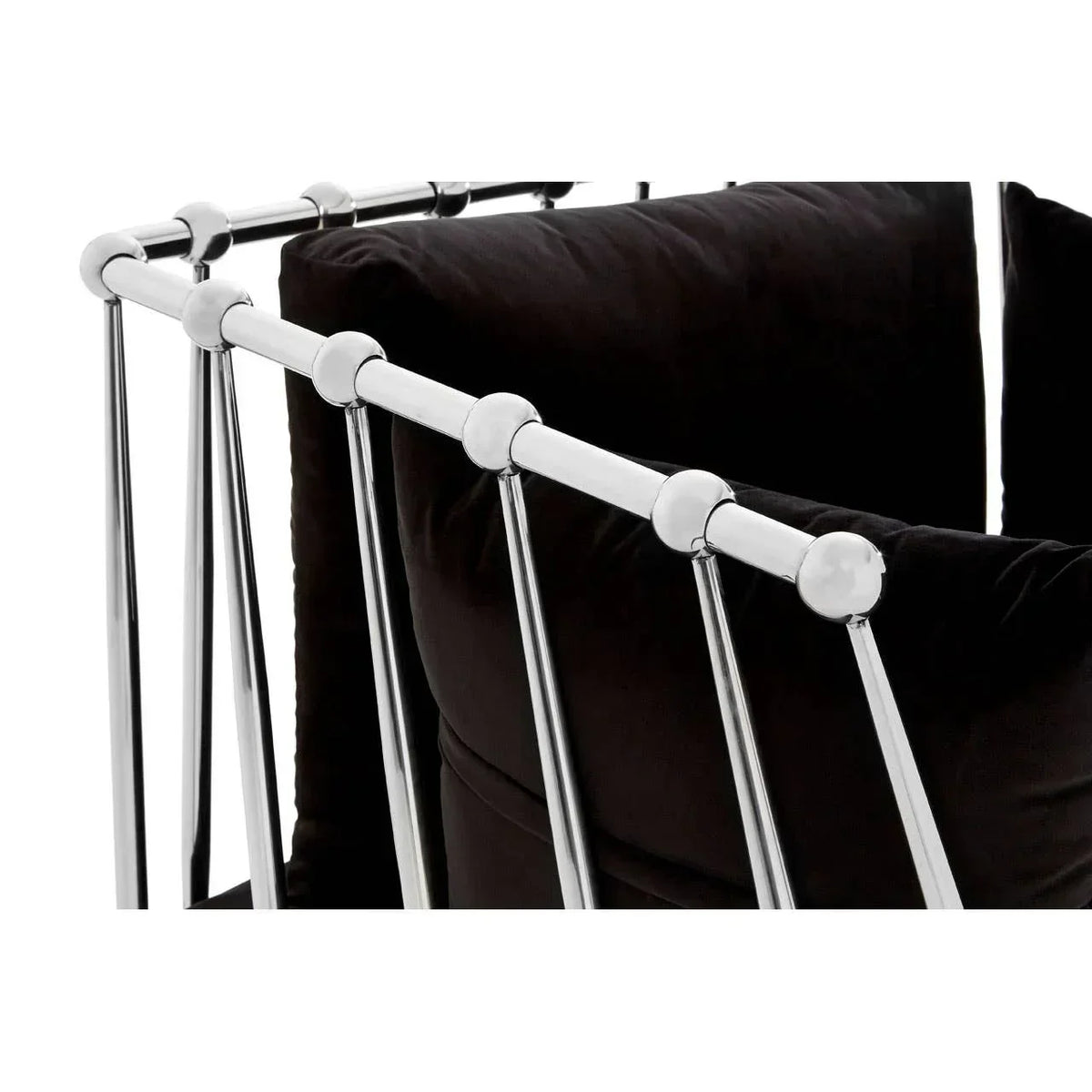 Modern sofa with chrome metal frame and plush black cushions, close-up view