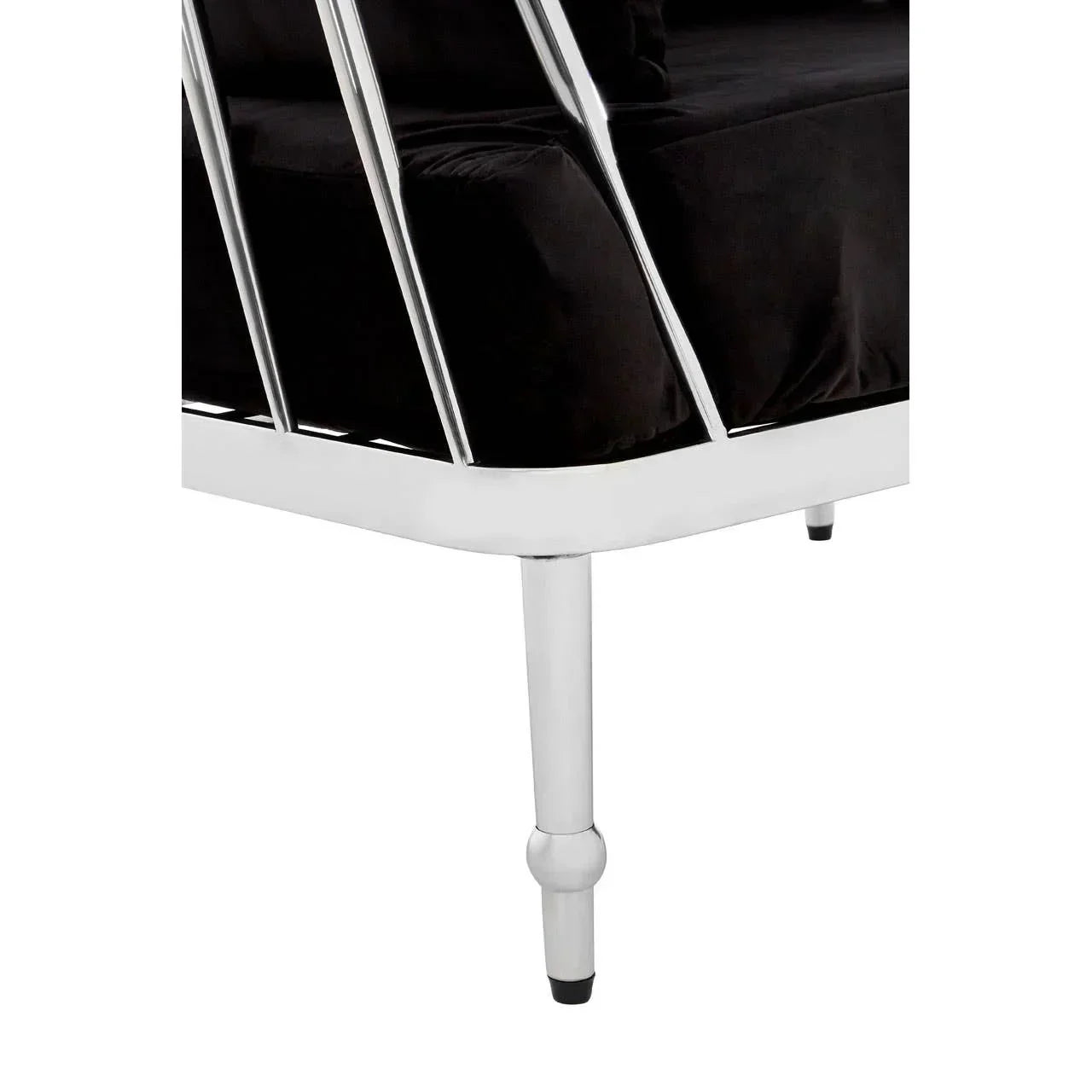 Close-up of silver metal sofa leg with black seat cushion