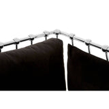 Black velvet upholstery covers the cushions of a three-seater sofa, featuring a sleek silver frame that outlines the backrest. The corner of the sofa shows a close-up of the frame's detailing, highlighting the elegant design and plush texture of the fabric