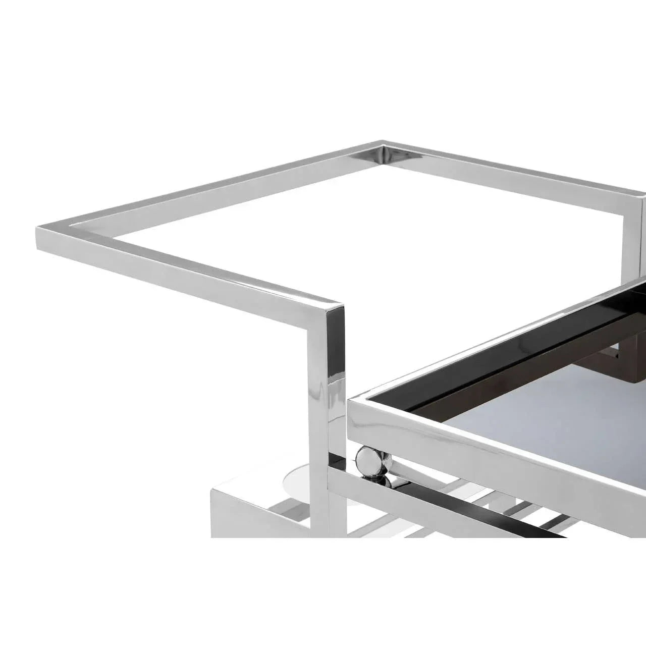 Chrome and glass coffee table corner with geometric metal frame and glossy black top