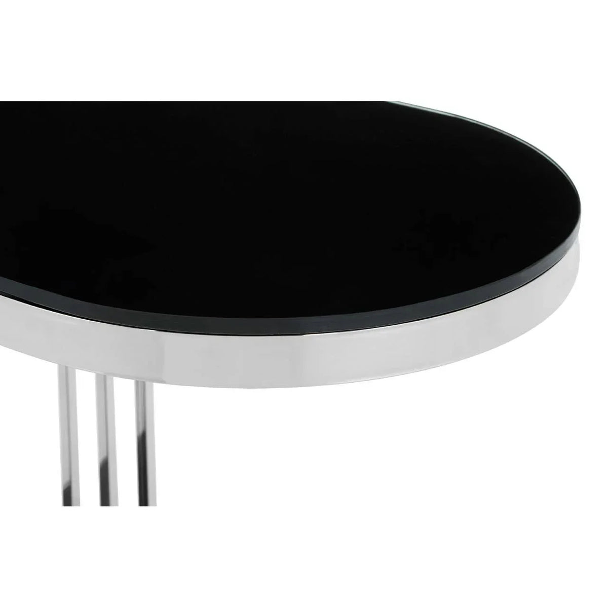 Close-up of round black glass table top with chrome edge and metal legs