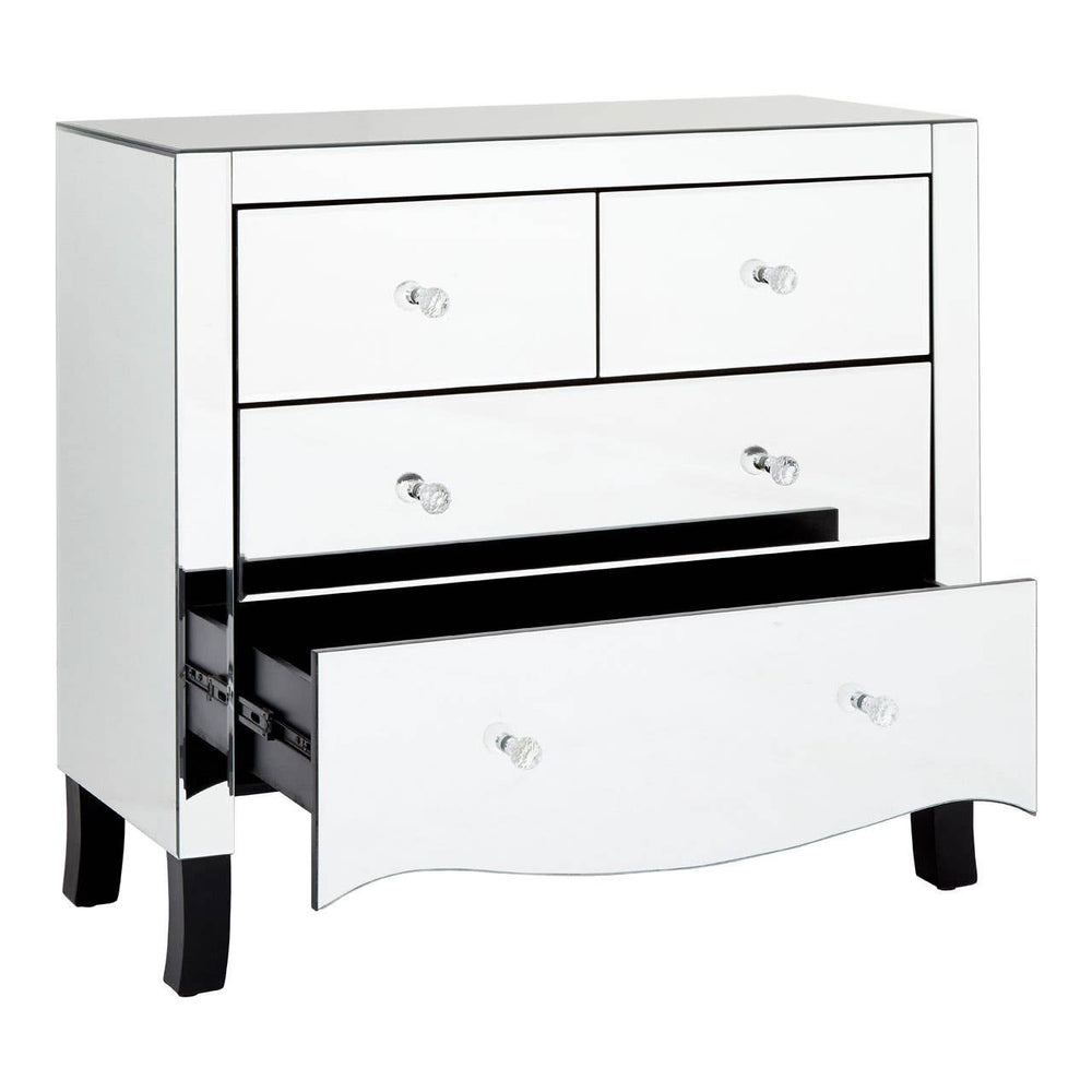 A white chest of four drawers featuring a sleek design with a mirror frame, showcasing three smaller top drawers and one larger bottom drawer partially open, revealing the interior. The chest is supported by short, curved legs
