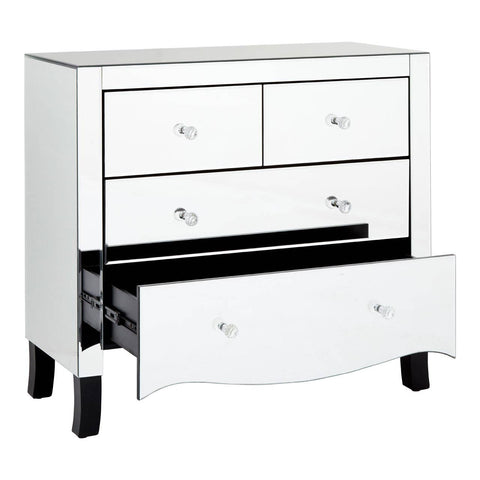 A white chest of four drawers featuring a sleek design with a mirror frame, showcasing three smaller top drawers and one larger bottom drawer partially open, revealing the interior. The chest is supported by short, curved legs