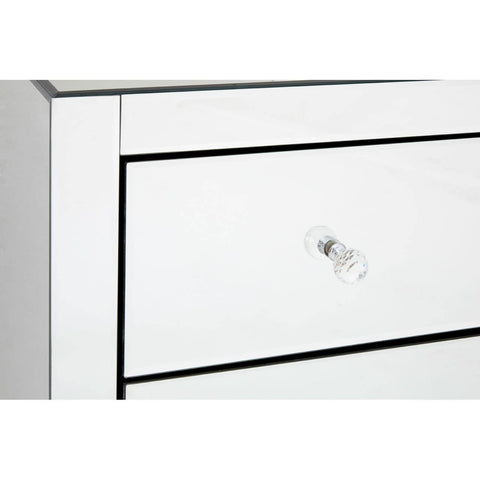 A close-up view of the Graciela Chest of 4 Drawers, featuring a sleek white finish with a subtle black outline around the drawers. Each drawer has a simple, elegant silver knob for easy access. The surface is smooth and reflective, enhancing the modern aesthetic of the furniture piece