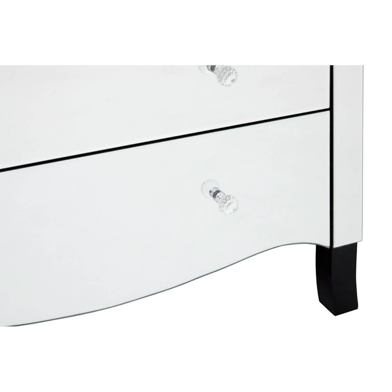 White chest of four drawers featuring a sleek design with a curved front and black feet. Each drawer has a clear crystal knob for easy opening. The surface is smooth and glossy, reflecting light
