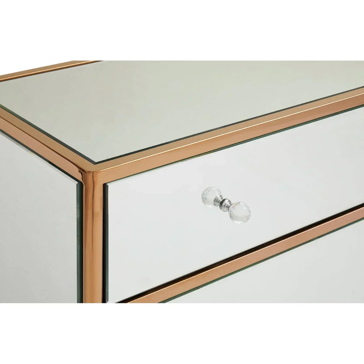 Mirrored bedside table with gold trim and glass drawer knob, close up of corner detail