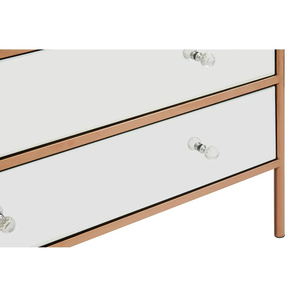 Mirrored chest of drawers with glass handles and rose gold metal trim, close-up view