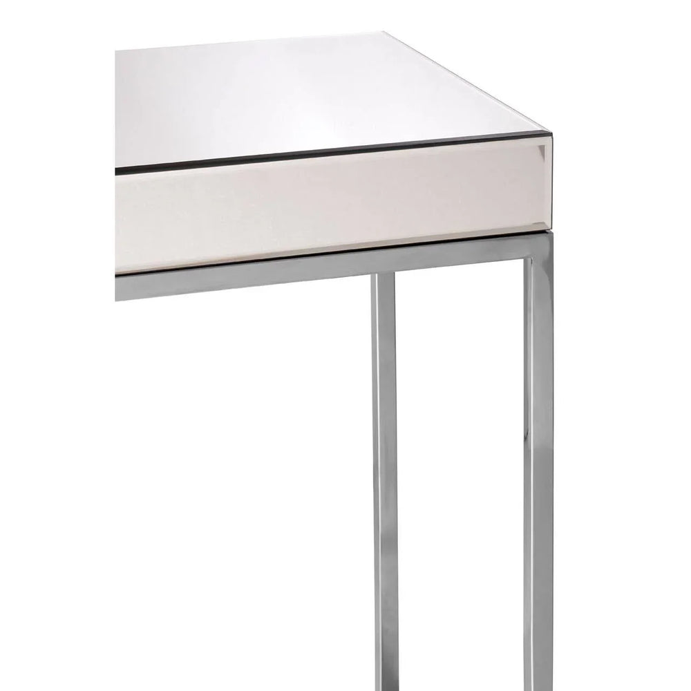 Mirrored console table with chrome metal legs and reflective top, corner close-up