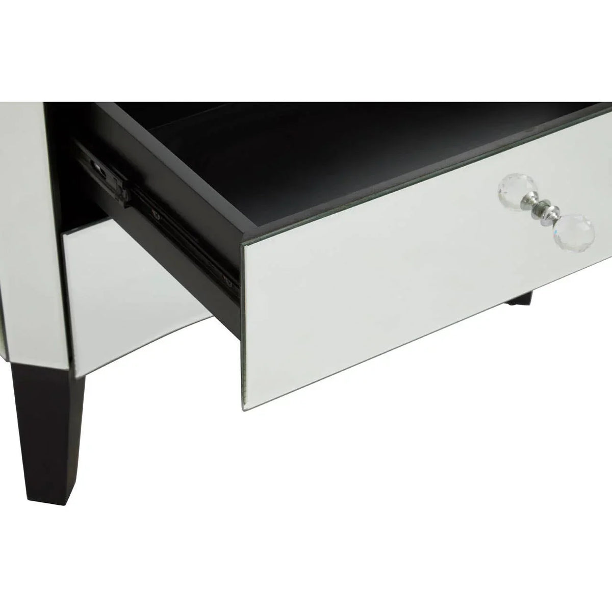 Mirrored bedside table with crystal handles and open drawer, black wooden legs visible
