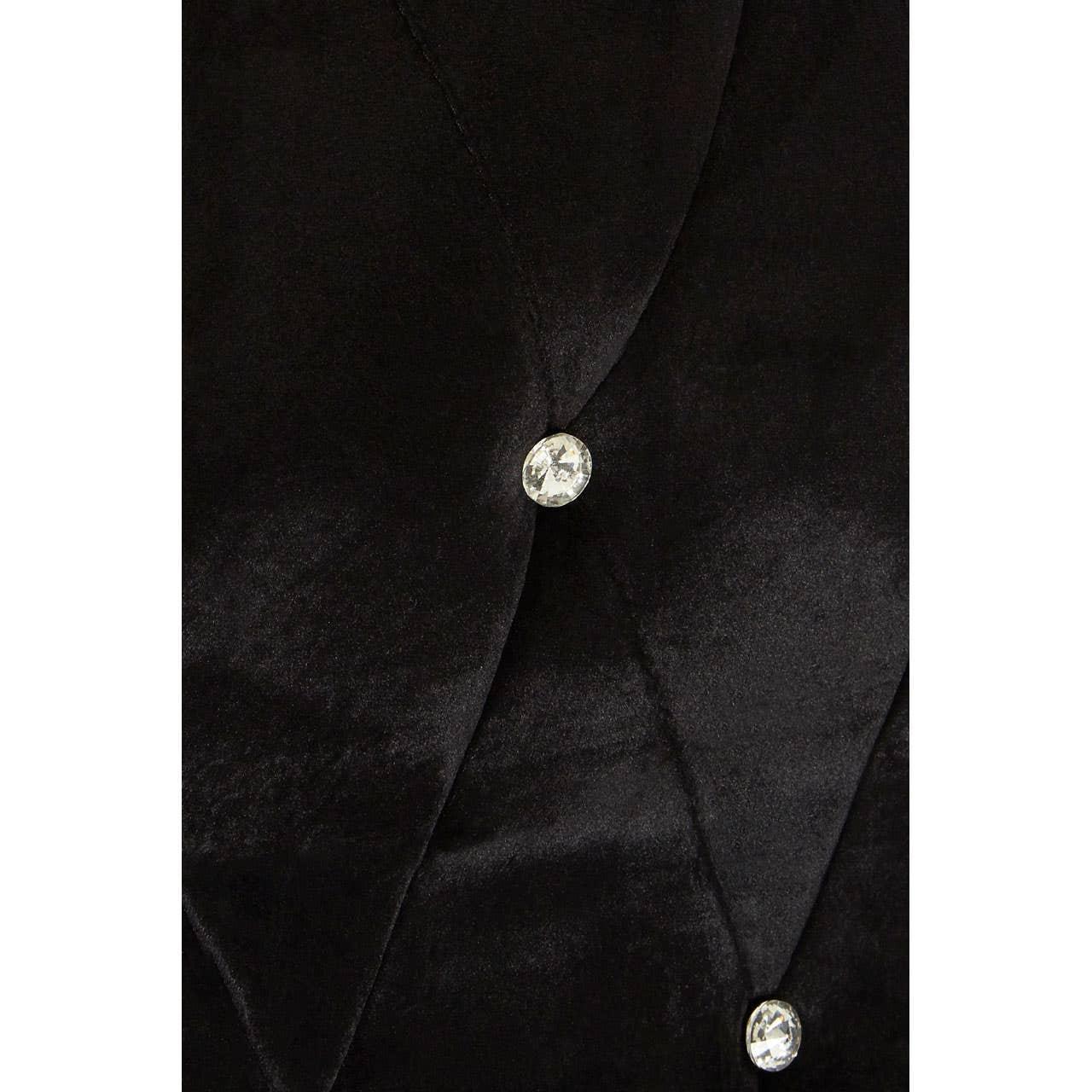 Black velvet upholstery with diamond button tufting detail on furniture