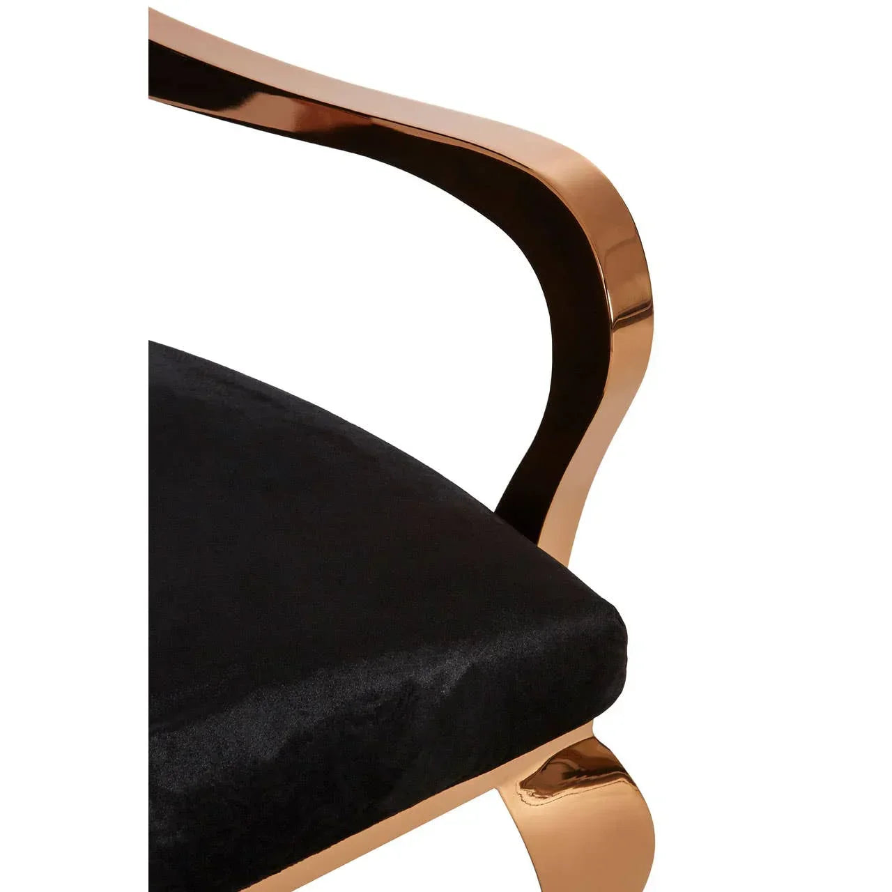Velvet dining chair with gold metal armrest and black upholstered seat close-up