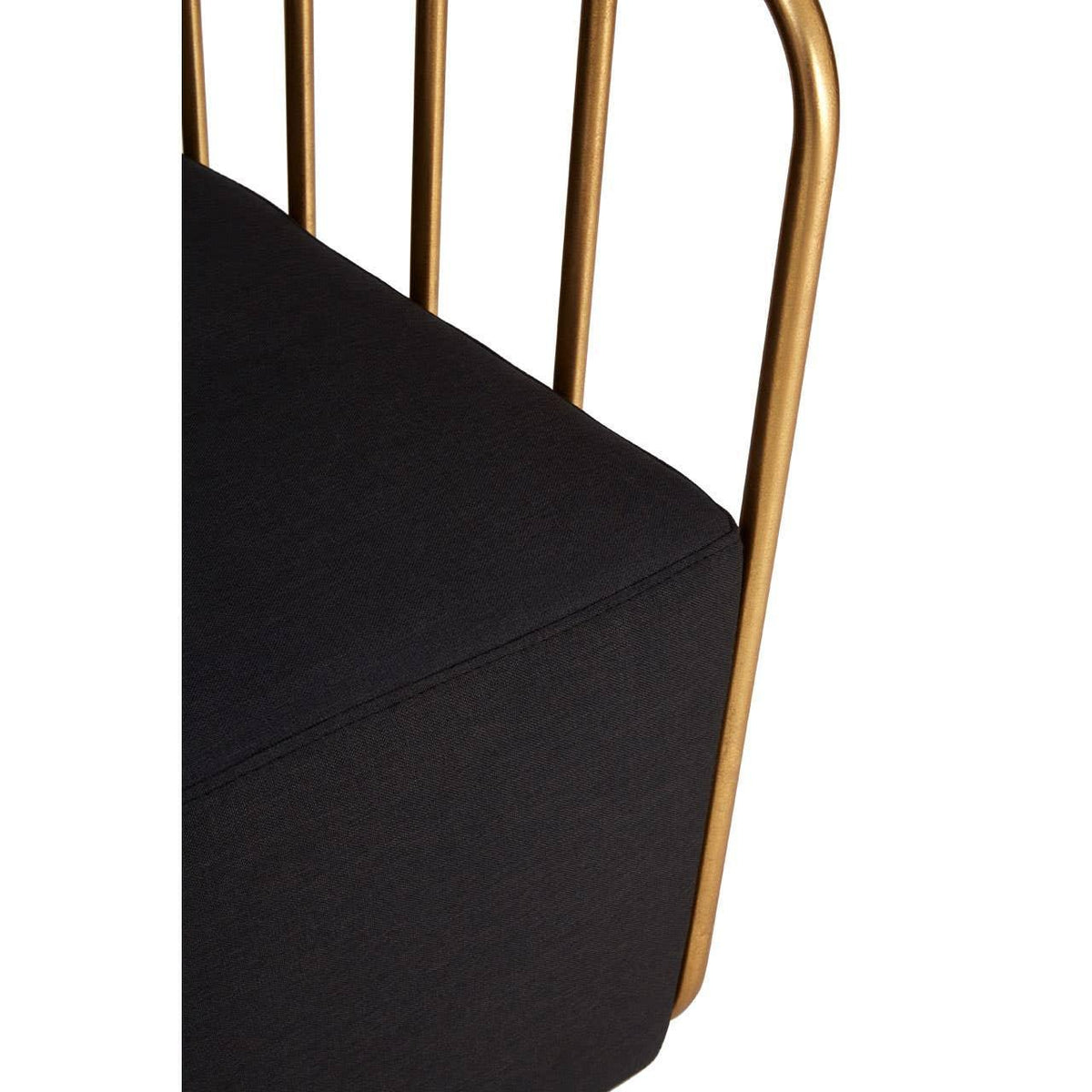 Closeup of a black fabric sofa seat with gold metal frame