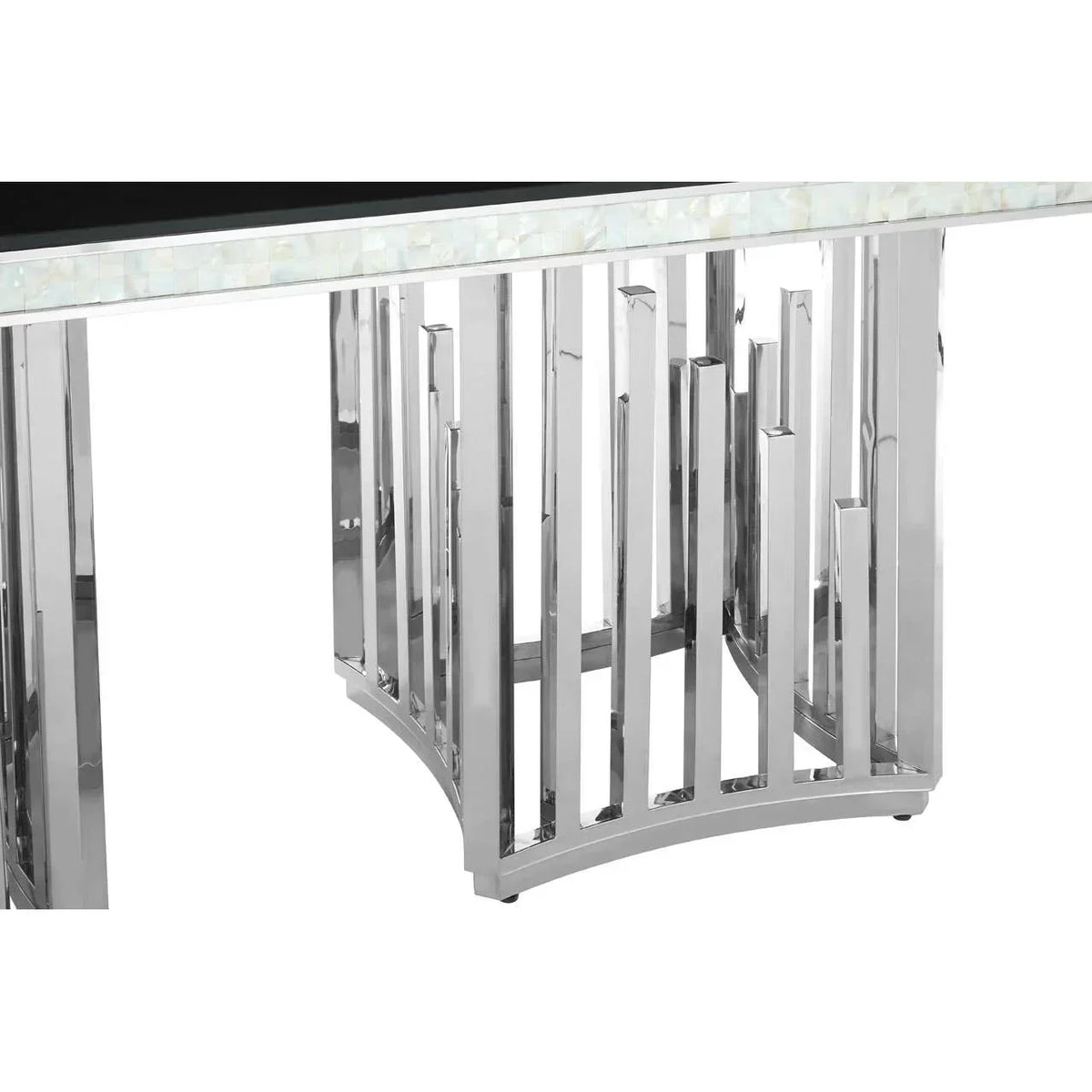 Close-up of chrome dining table base with geometric metal legs and stone inlay edge