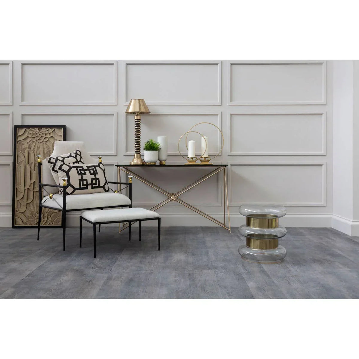 Modern accent chair with ottoman, gold console table and glass stool in stylish living room