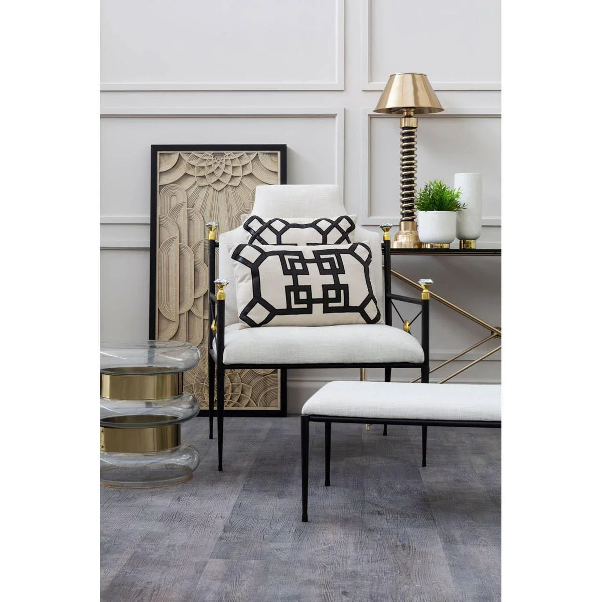 Modern accent chair with geometric cushion and white ottoman in minimalist living room