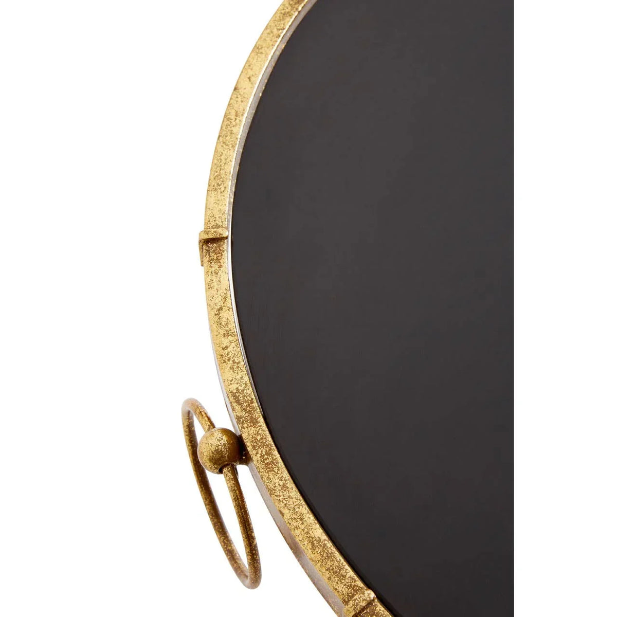 Close-up of black round metal side table with gold rim and decorative ring detail