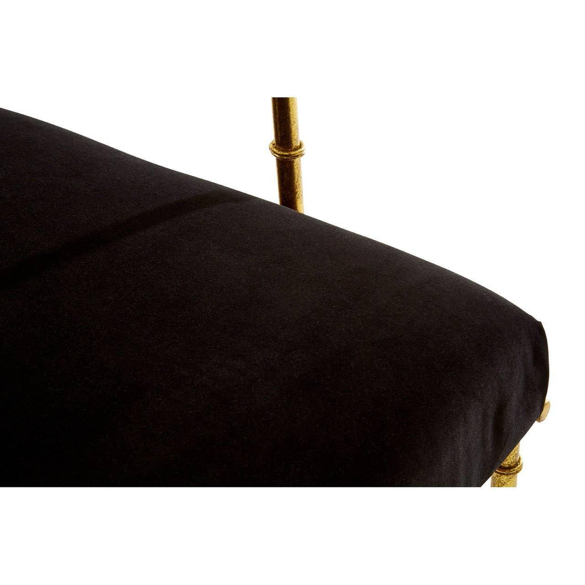 Black velvet dining chair seat with gold metal leg detail closeup