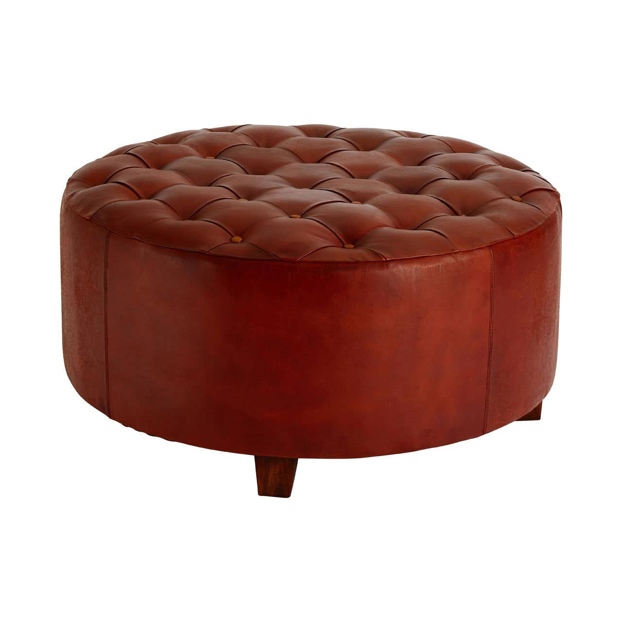 Round large stool upholstered in antique brown leather with button tufting on the top surface, featuring short wooden legs