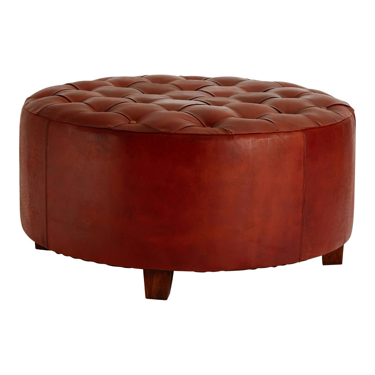Round large stool upholstered in antique brown leather with button tufting on the top surface, featuring short wooden legs