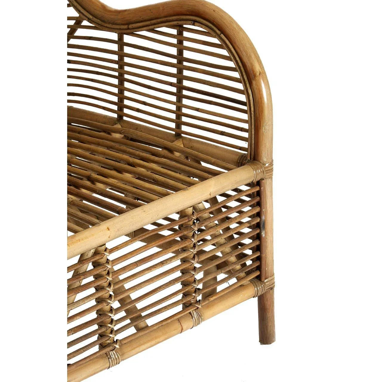 Closeup of natural rattan armchair frame showing curved arm and woven seat detail