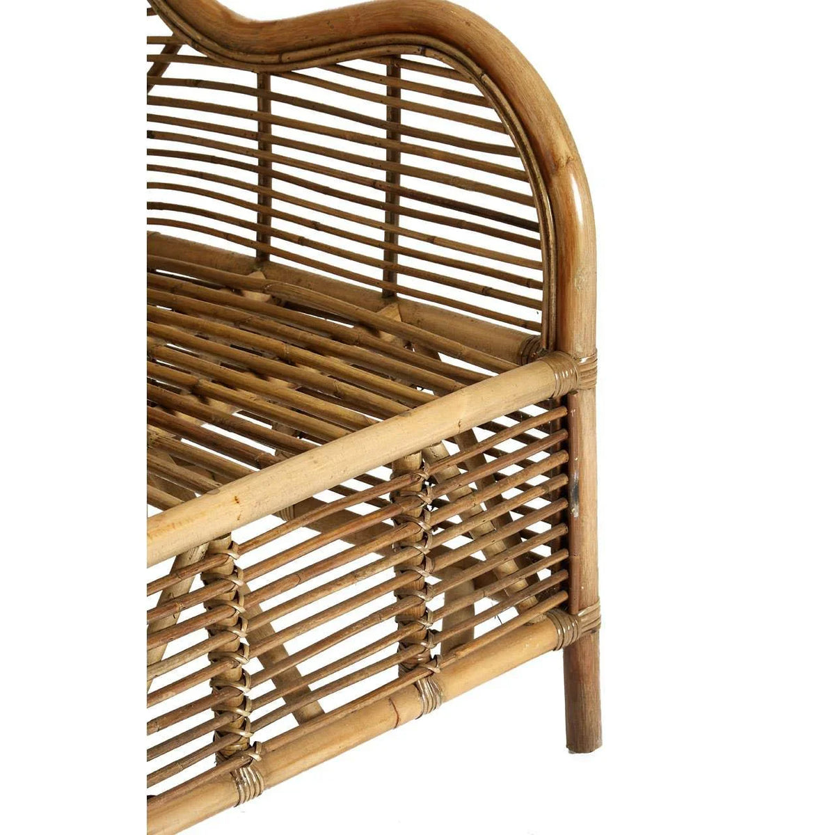 Closeup of natural rattan armchair frame showing curved arm and woven seat detail