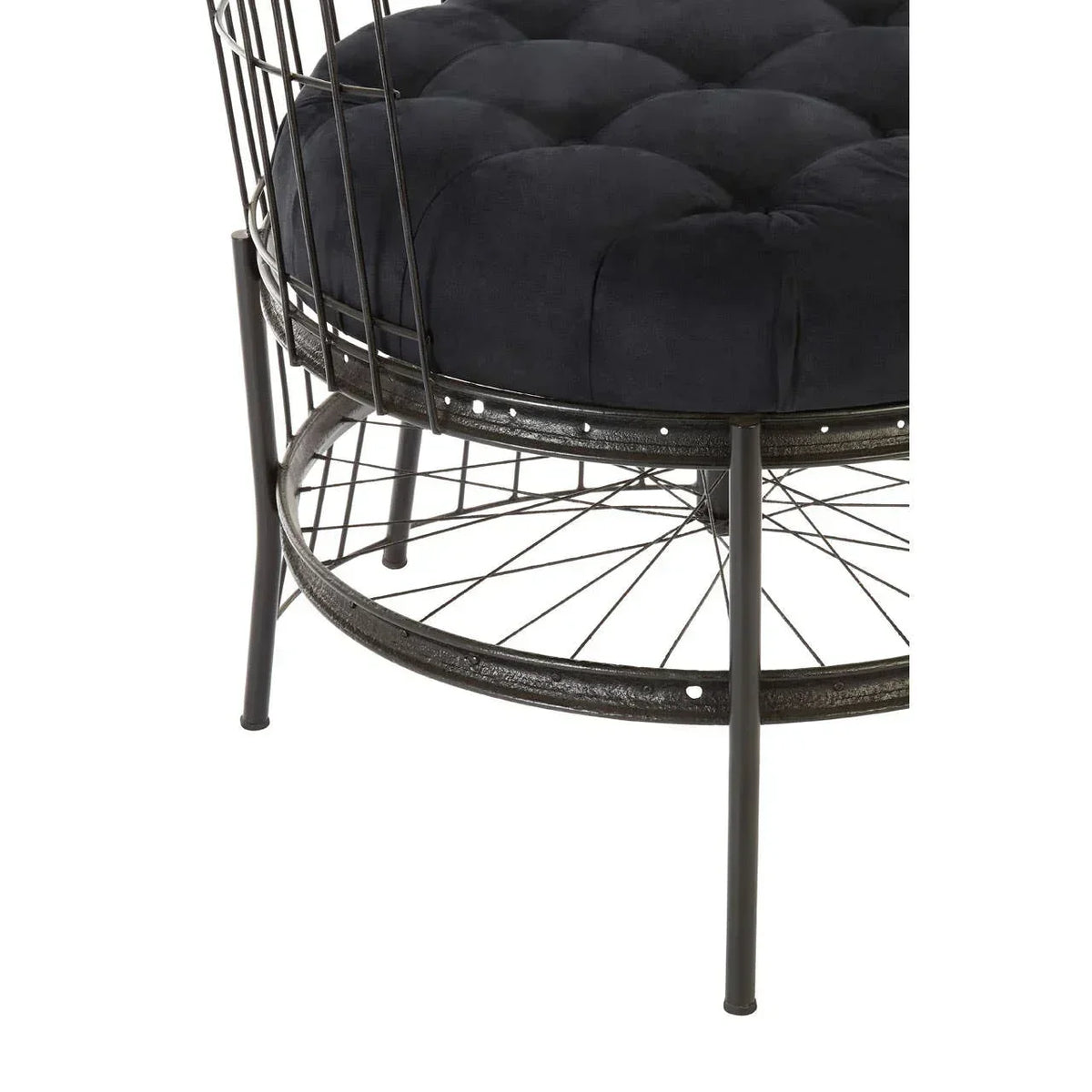 Black velvet cushioned accent chair with metal wire frame and round base, close view