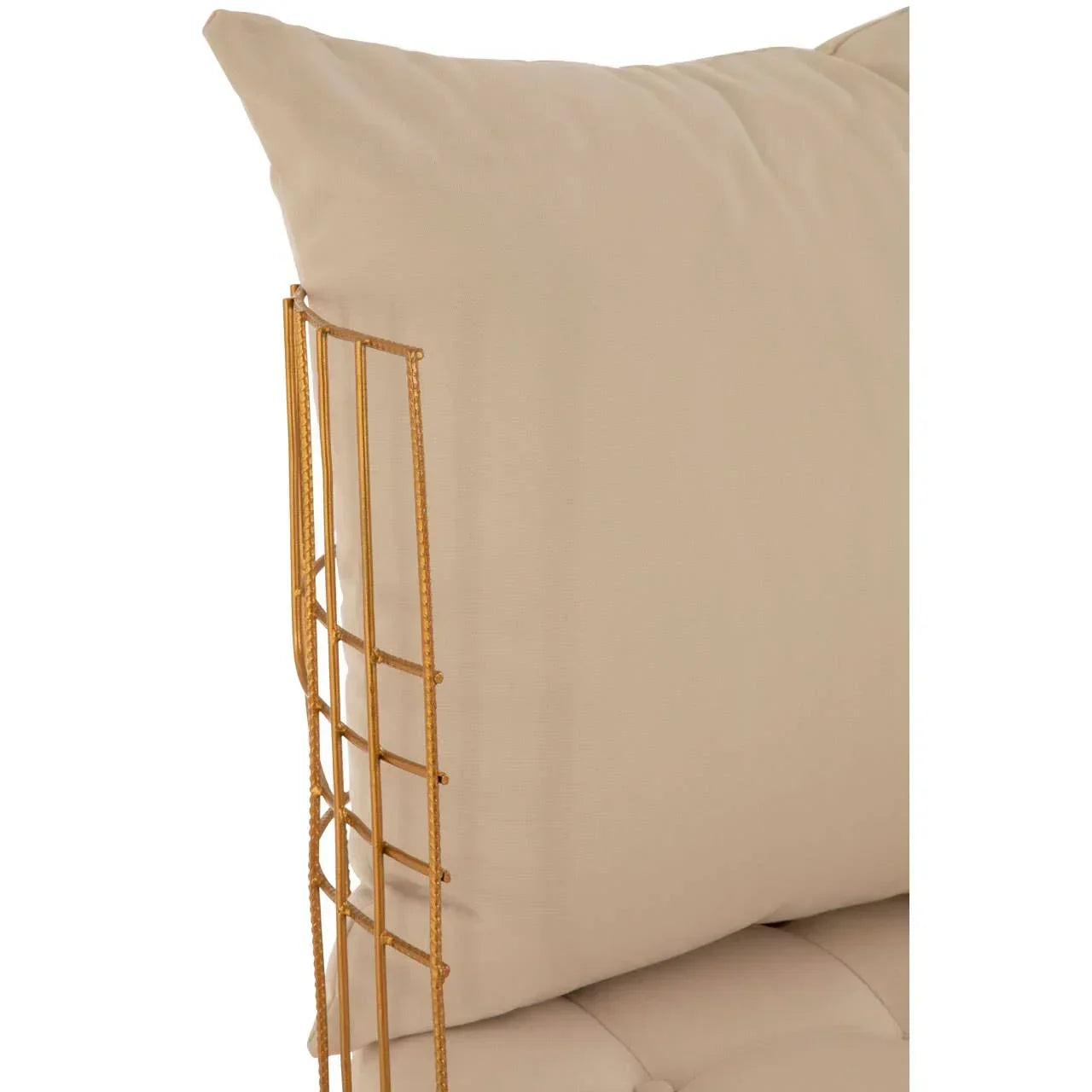 Close-up of beige sofa cushion with gold metal frame detail
