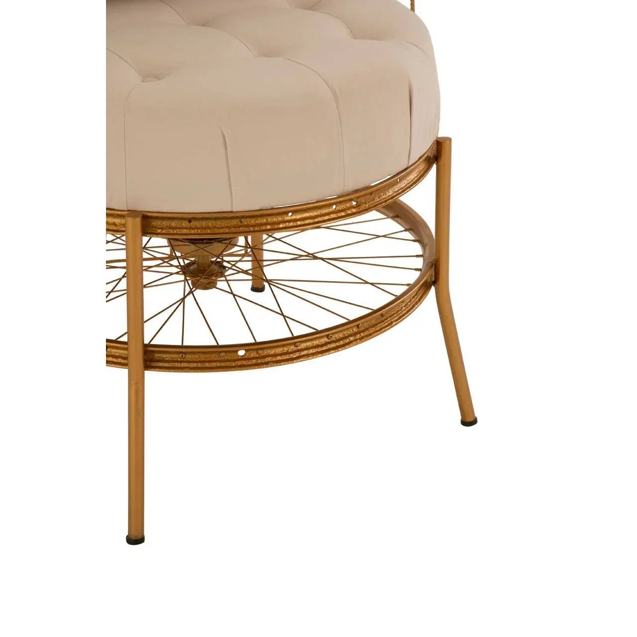 Detail of beige upholstered stool with gold metal legs and circular wire shelf