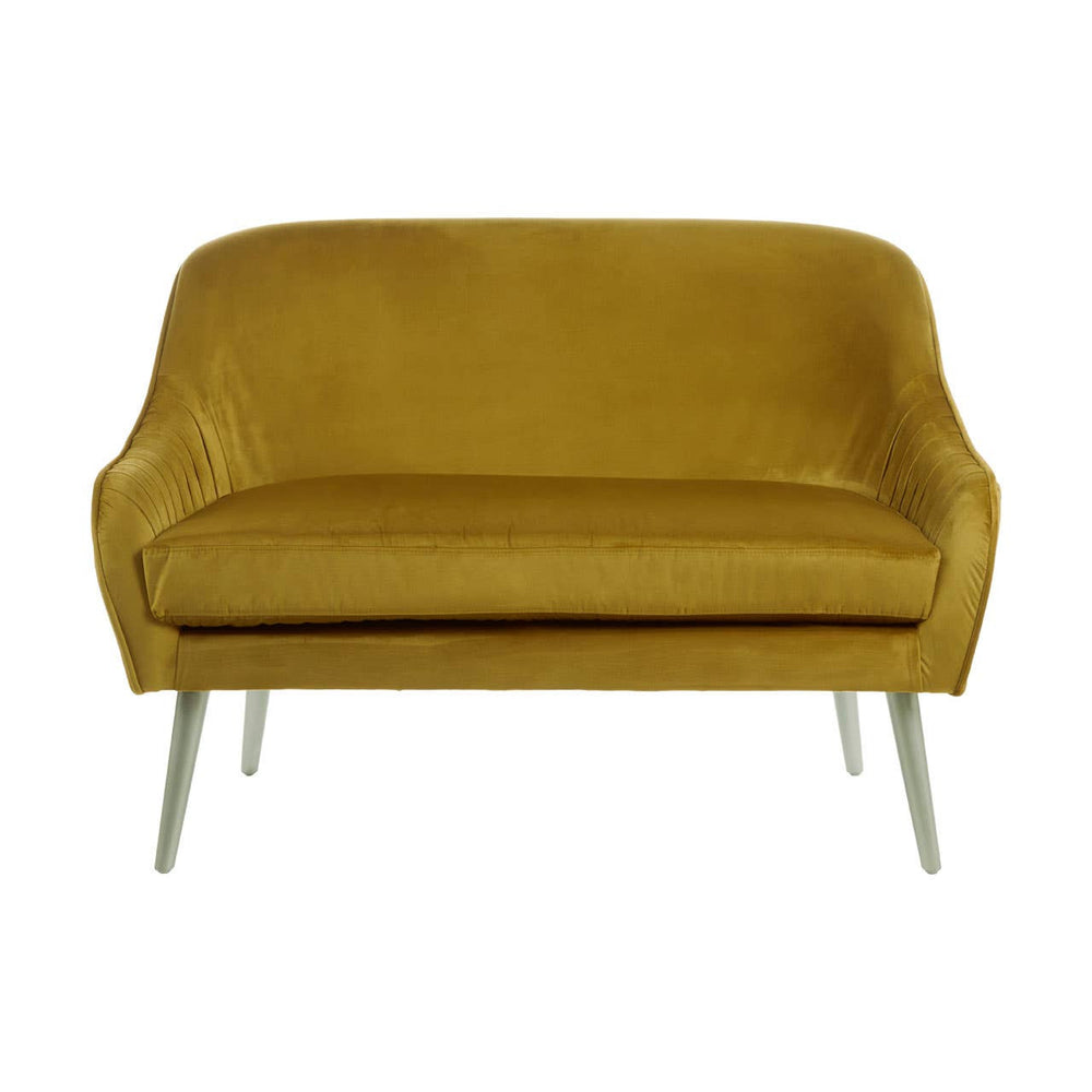 A mustard velvet two-seater sofa with a smooth, plush surface and rounded armrests, supported by sleek, metallic legs. The sofa features a minimalist design, showcasing a contemporary style suitable for various interior decor