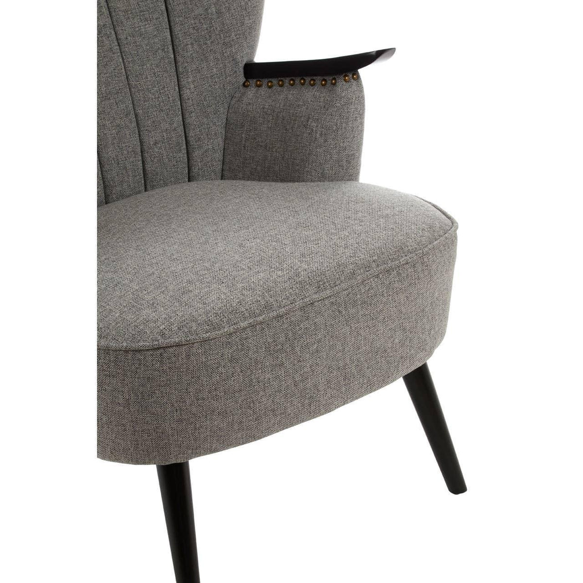 Close-up of grey fabric accent chair with tapered black legs and armrest stud detail
