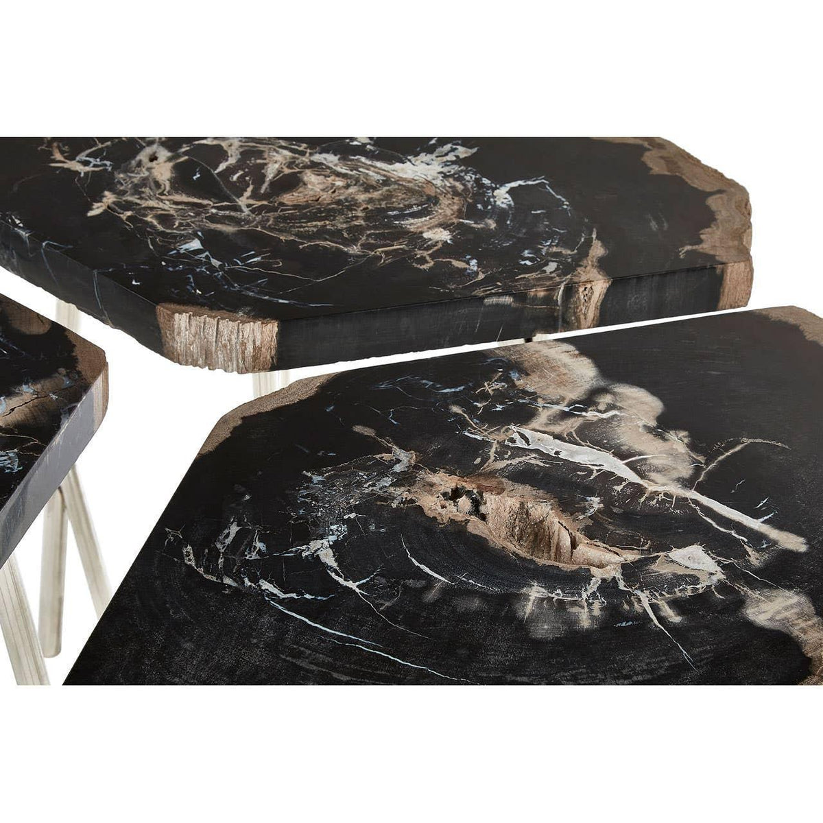 Black petrified wood nesting tables with irregular edges and natural stone texture