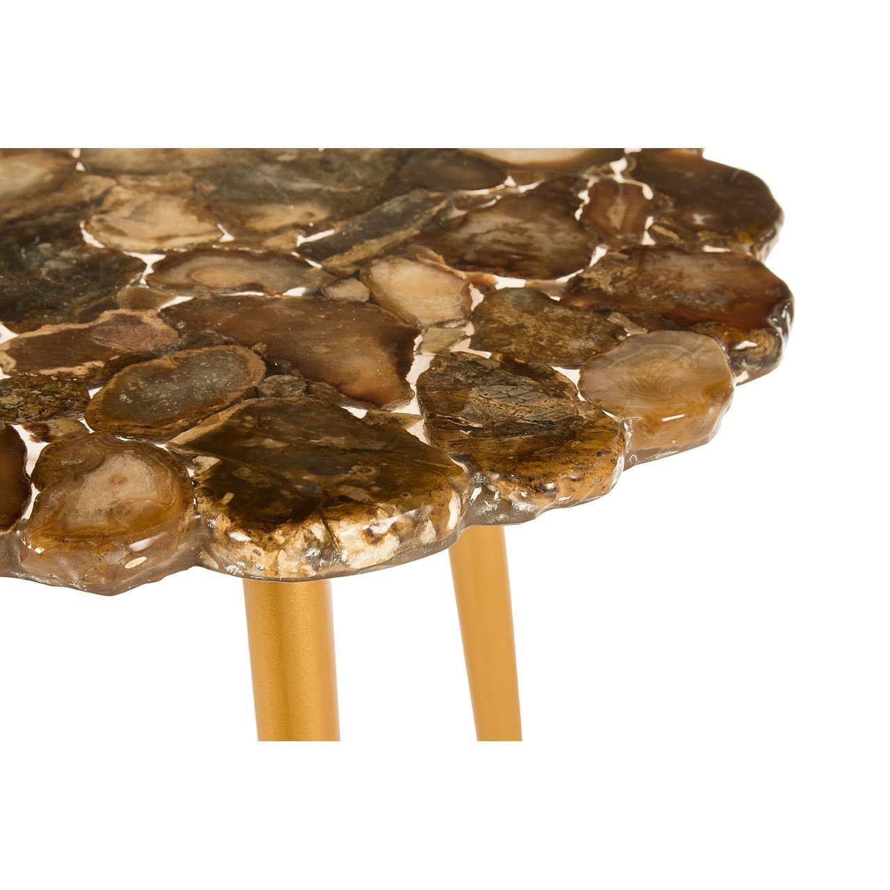 Round petrified wood side table with gold metal legs, close-up of textured tabletop