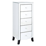 White chest of five drawers featuring a sleek design with a mirror frame and silver accents, standing on black legs. Each drawer has a simple silver handle, and the overall finish is glossy, giving it a modern look