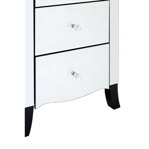 White chest of drawers featuring five spacious drawers with sleek silver knobs, a curved bottom edge, and elegant black legs. The design includes a mirror frame that enhances its modern aesthetic