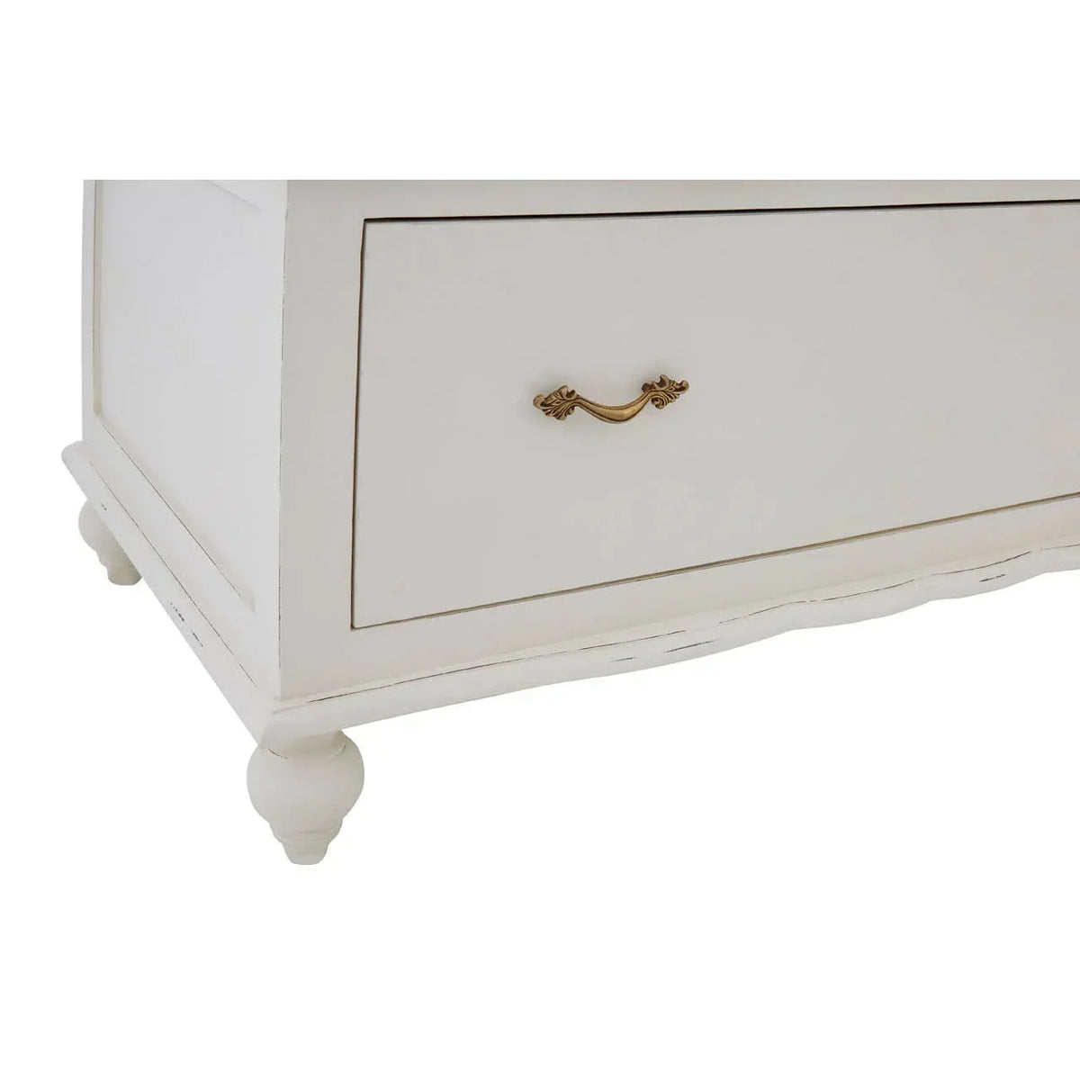 Close view of cream wooden drawer with gold handle and carved bun feet