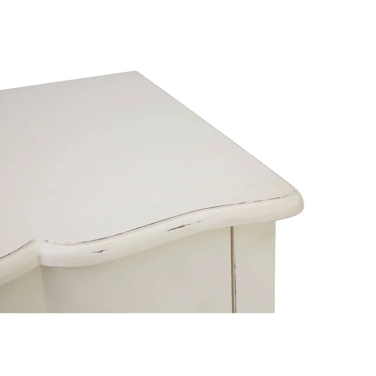 Distressed white wooden furniture corner with curved edge and visible wood grain detail