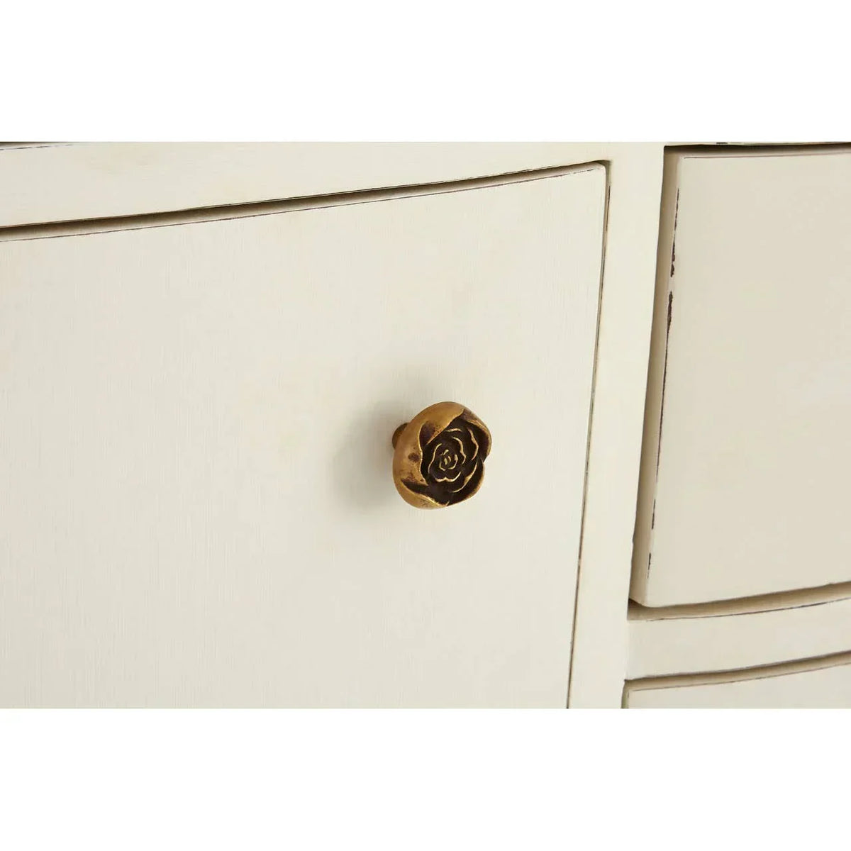 Cream wood cabinet drawer with gold rose shaped knob detail