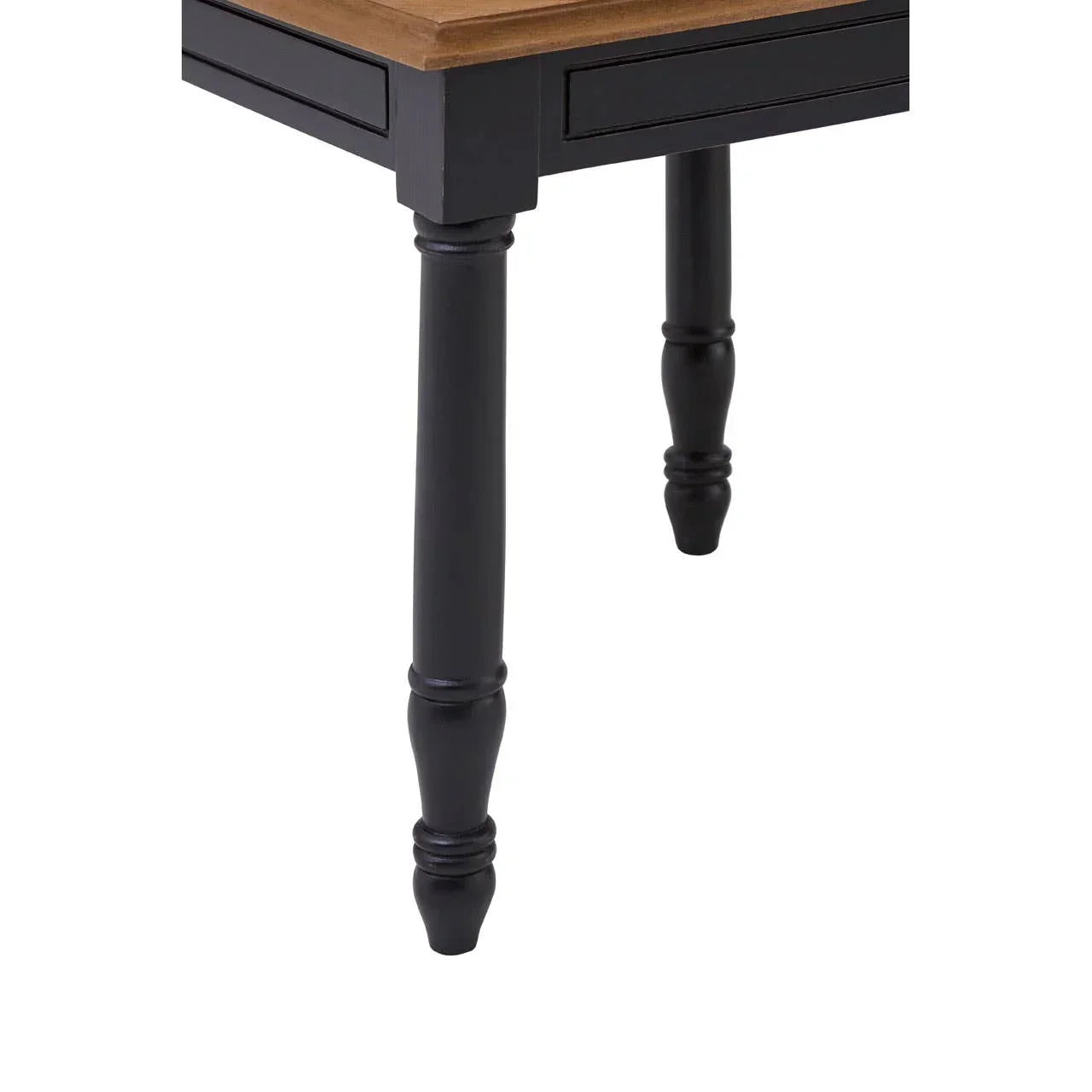 Closeup of black dining table leg with wood top and carved detail
