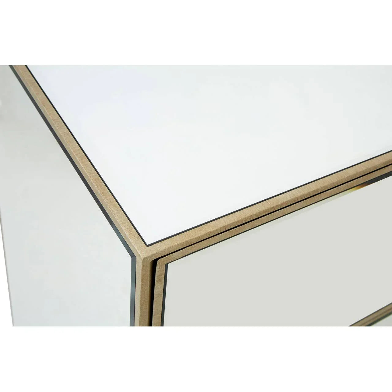 Mirrored bedside table corner with gold trim detailing