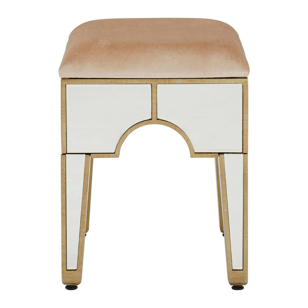 Champagne gold and mirrored stool with a rectangular cushioned top in a light beige color, featuring a sleek design with gold trim and tapered legs. The front has an arch-shaped cutout, enhancing its elegant appearance