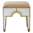 Champagne gold and mirrored stool with a soft, beige upholstered top and decorative gold trim, featuring a unique arch design on the front and sleek, tapered legs