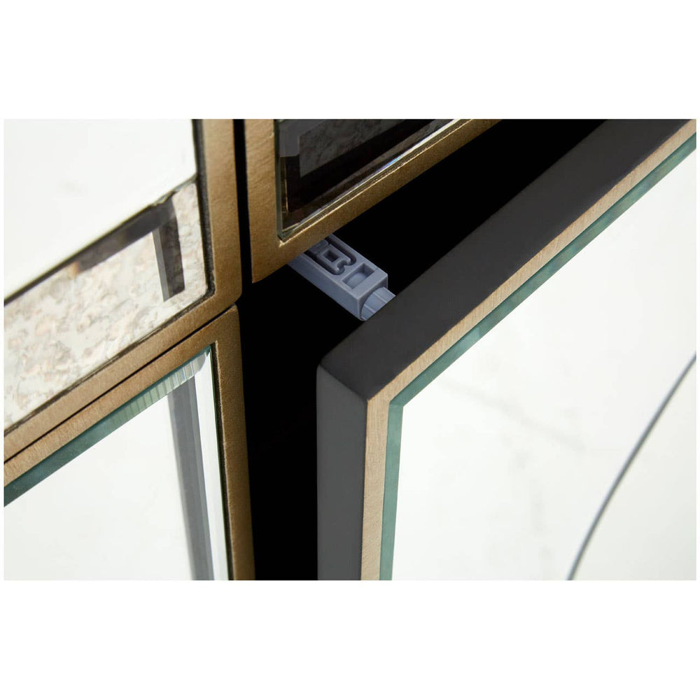 Champagne gold and mirrored sideboard featuring a sleek design with a reflective surface, showcasing elegant geometric lines and a polished finish. The corners are accented with gold trim, enhancing the luxurious appearance