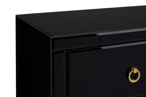Black cabinet with a sleek, modern design featuring a smooth top surface and a single drawer with a circular gold handle. The cabinet has clean lines and a glossy finish, emphasizing its contemporary aesthetic